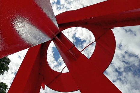 Blick von unten in die rote Metallskulptur L´Allumé am Rheinufer